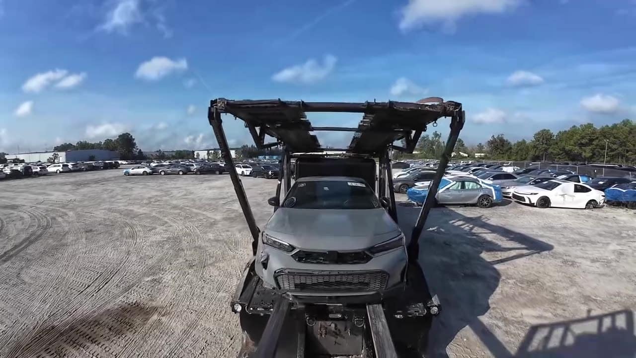 Unloading at the yard, sped up 5×: a forklift takes an SUV off the car carrier