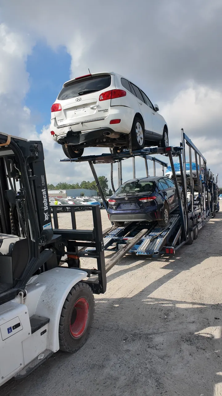 Vehicle unloaded from a flatbed truck with a forklift